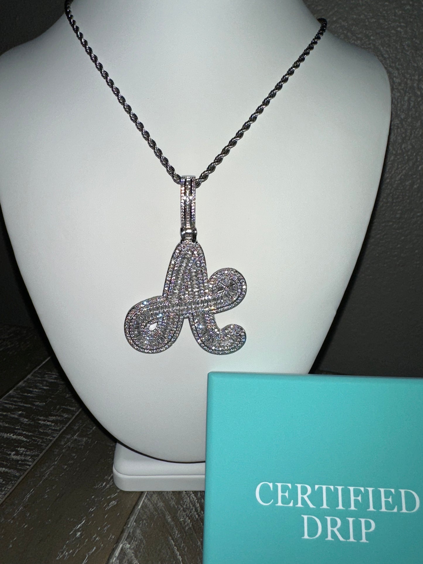 Image of silver Icy baguette cursive initial pendant. 